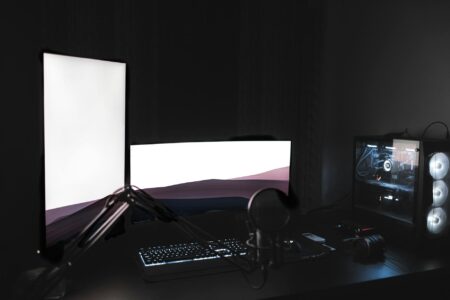 How Professional Esports Athletes Are Using Sleep Optimization Technology for Peak Performance Gaming computer setup with multiple monitors in dimly lit room showing professional esports environment