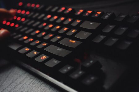Why Fighting Game Pros Are Switching to Mechanical Keyboard Controllers Close-up of a mechanical gaming keyboard with RGB lighting and custom keycaps