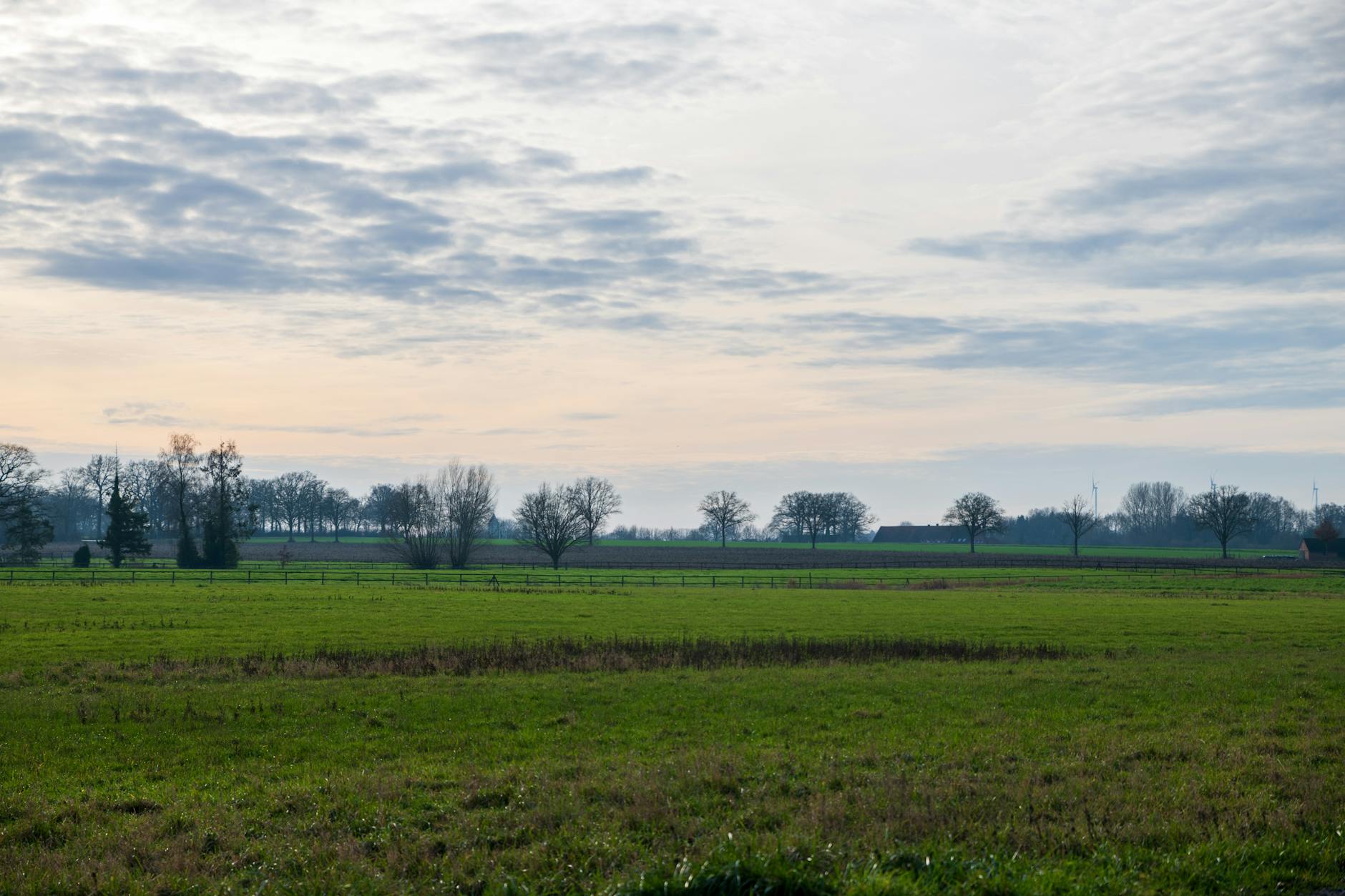 Person holding smartphone in rural mountainous landscape searching for cellular signal