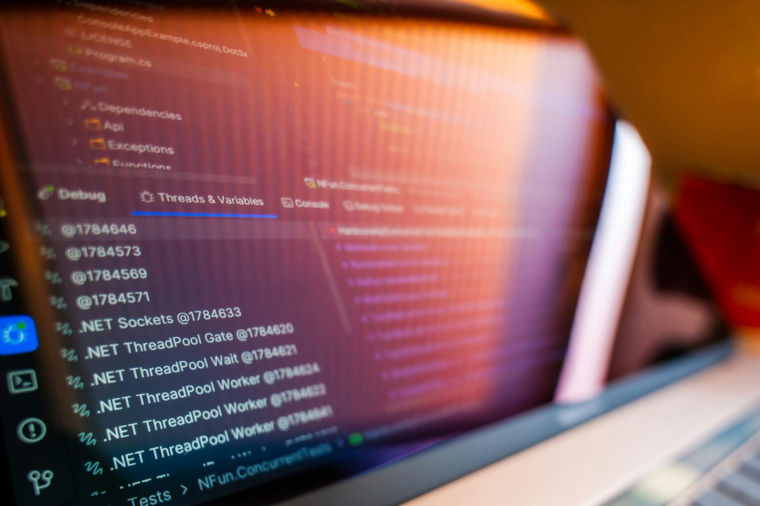 Developer working on code displayed on laptop screen with modern development environment