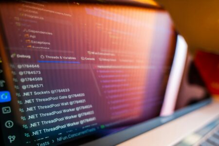 How Browser-Based Code Editors Are Replacing Visual Studio for Remote Development Developer working on code displayed on laptop screen with modern development environment