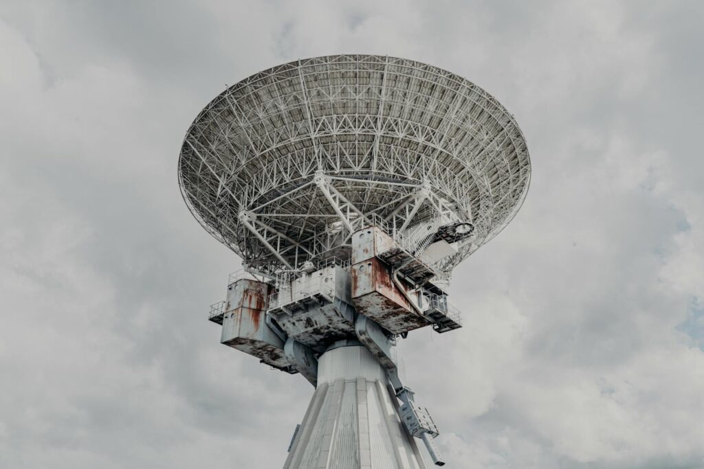 Satellite communication dish against blue sky representing satellite messaging technology