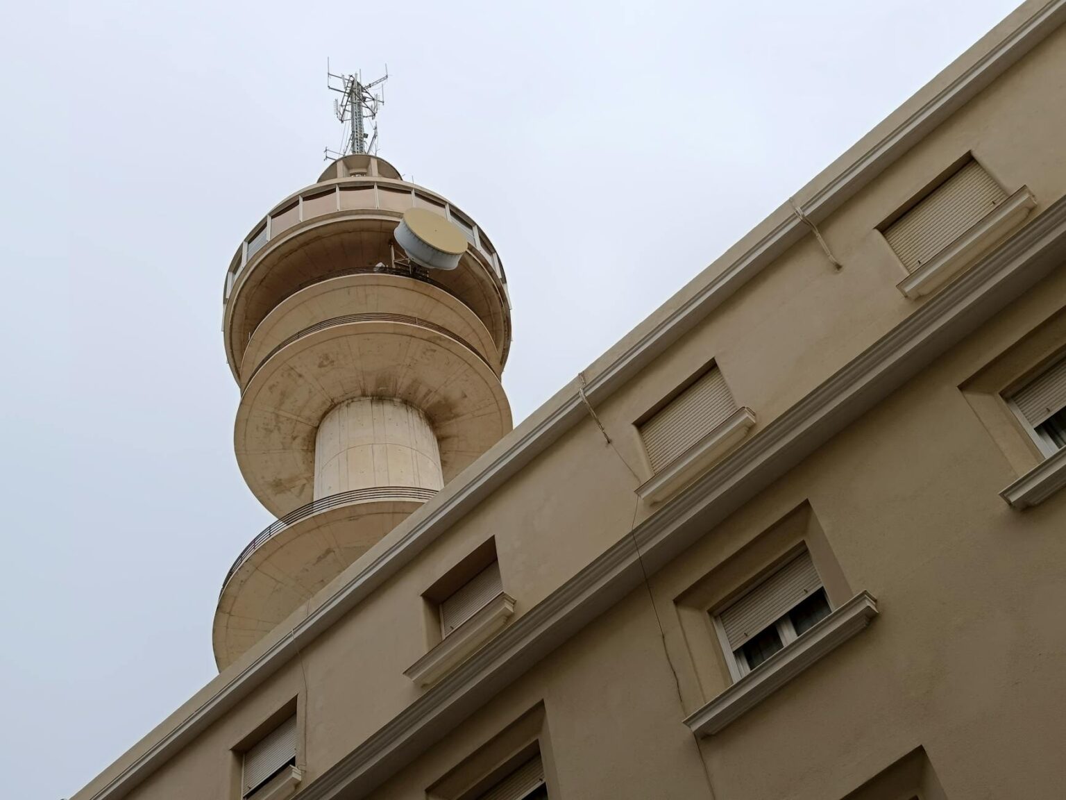 Cell phone tower against blue sky representing traditional cellular network infrastructure