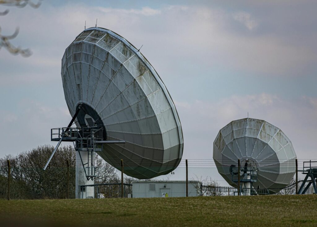 Satellite Internet Integration Makes Rural 5G Coverage Financially Viable Large satellite communication dish against blue sky, representing satellite internet technology for rural connectivity