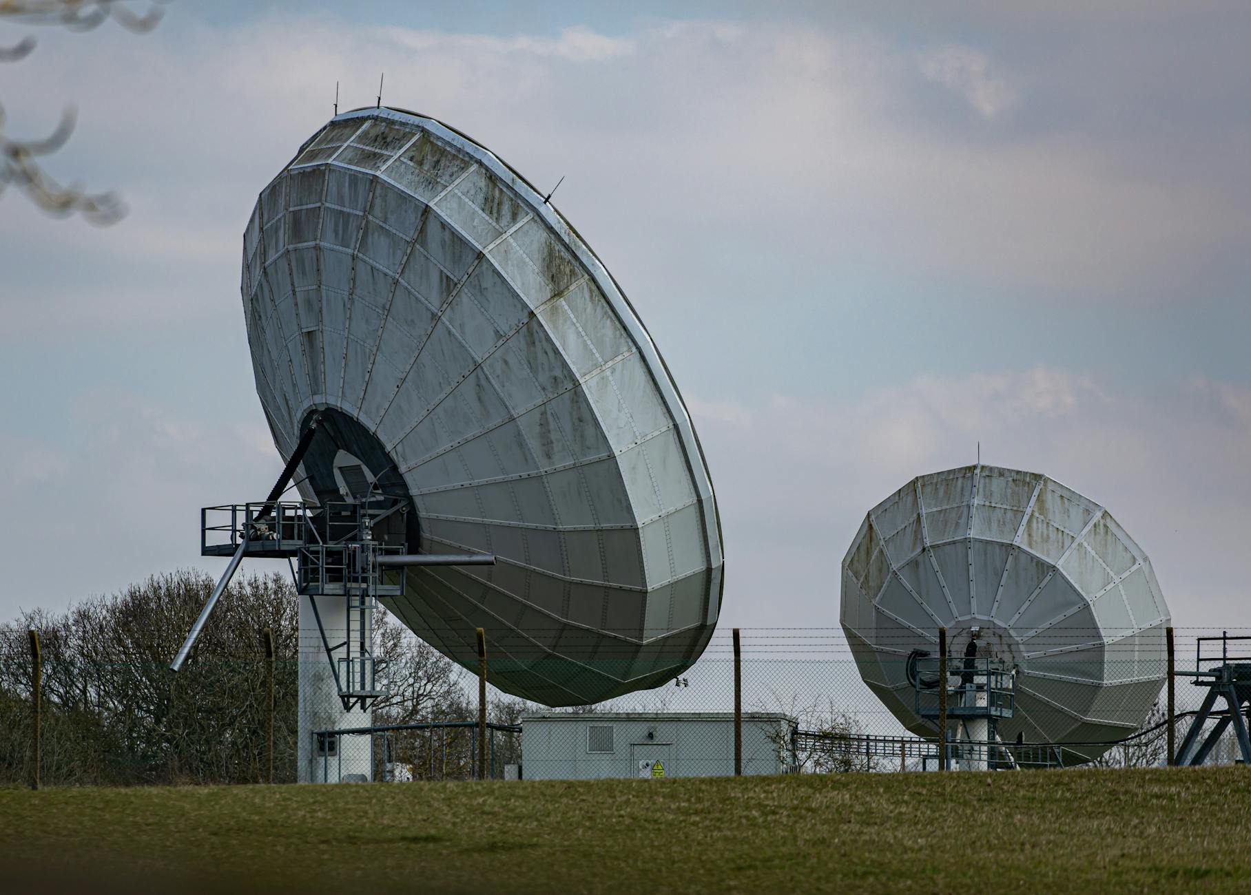 Large satellite communication dish against blue sky, representing satellite internet technology for rural connectivity