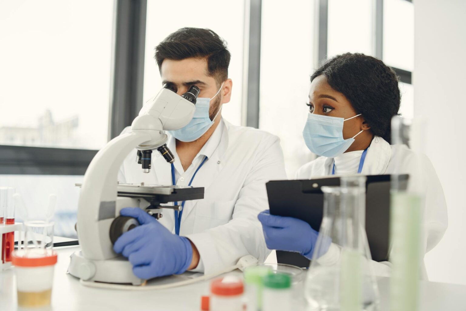 Scientists working in modern medical research laboratory with advanced equipment for gene therapy development