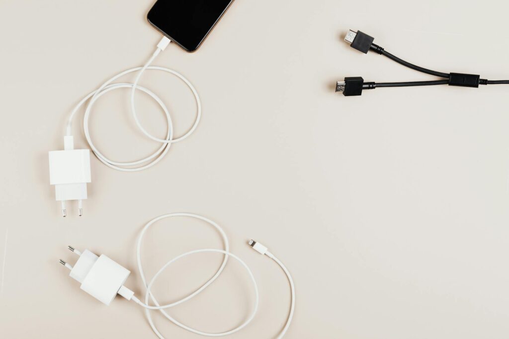 Why Flagship Phones Are Dropping Wireless Charging for Faster Wired Solutions Modern smartphone connected to fast charging cable on desk