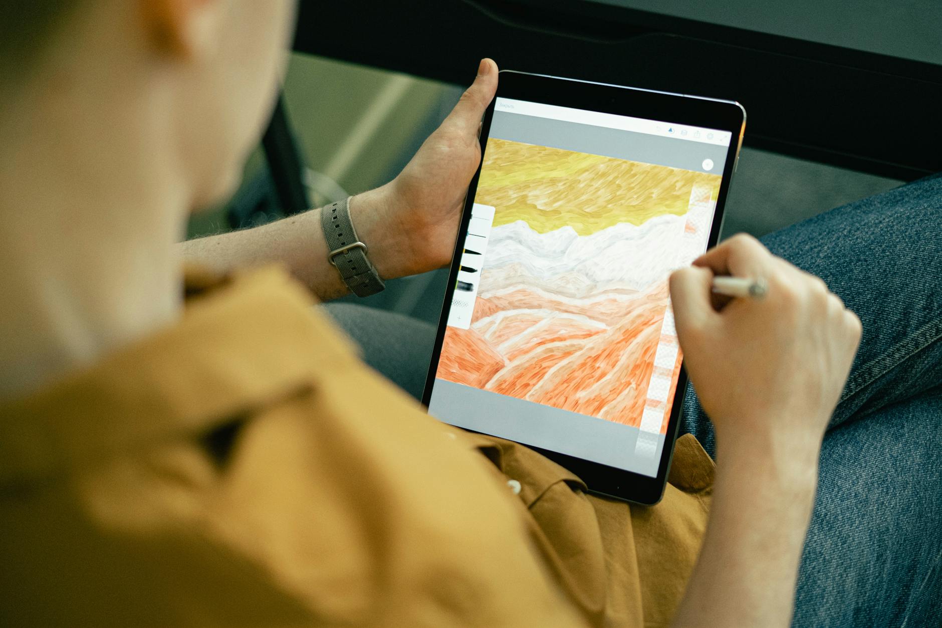 Digital artist creating artwork on mobile device with stylus pen