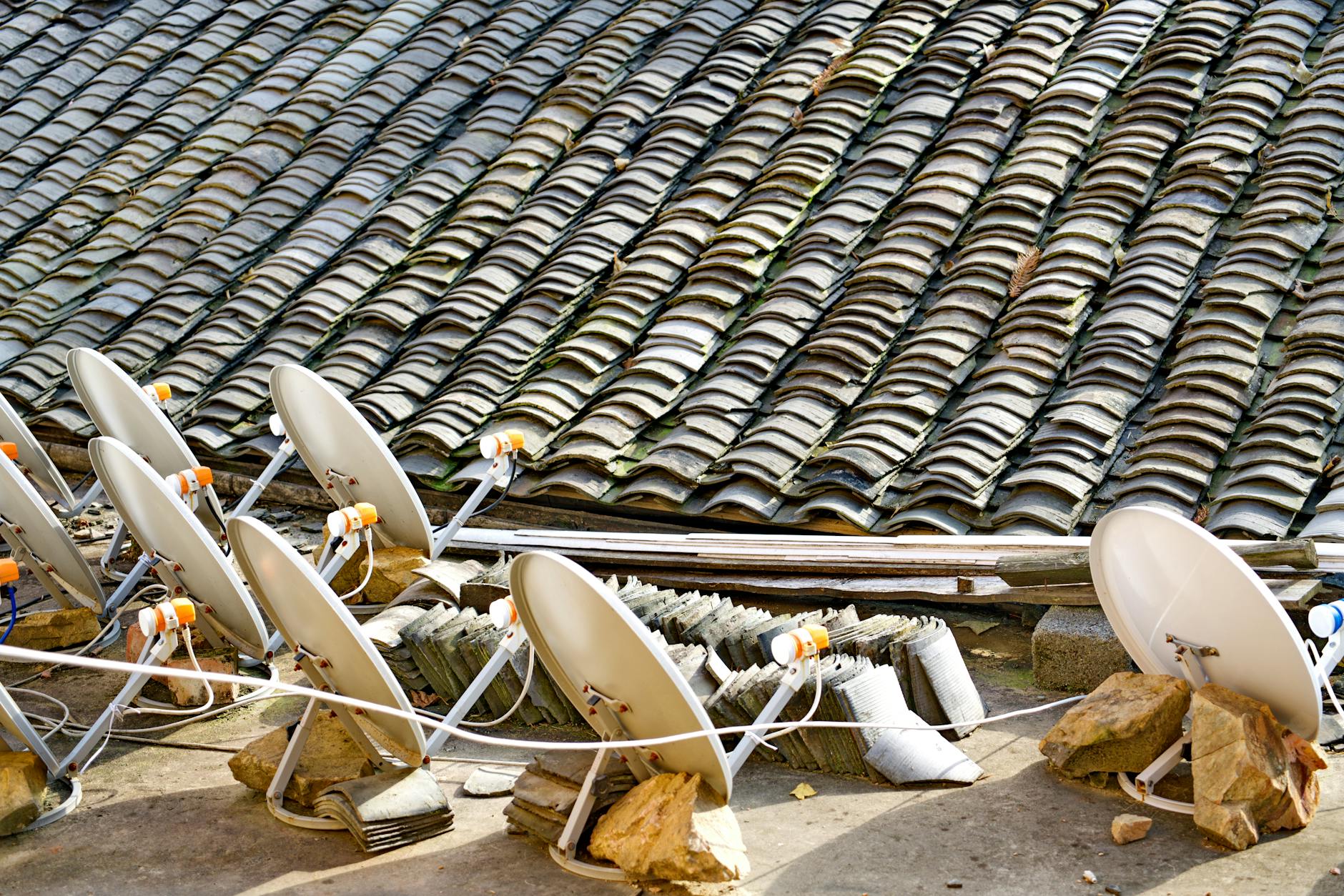 Modern satellite communication dish against blue sky representing satellite internet infrastructure
