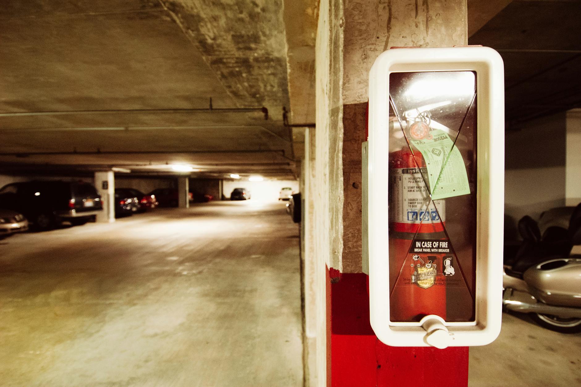 Indoor parking garage with marked spaces and concrete flooring