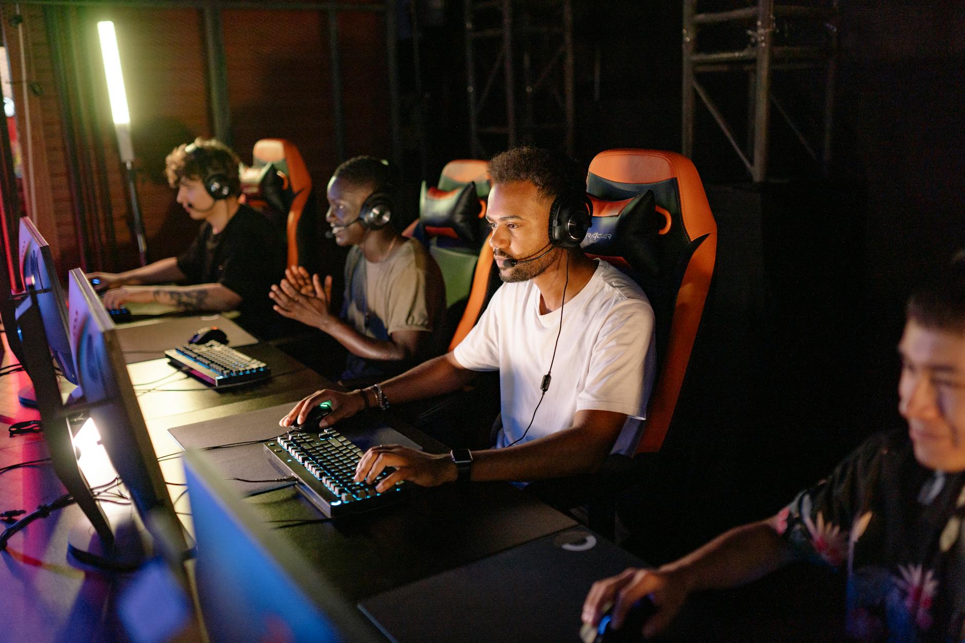 Professional esports tournament stage with multiple gaming stations and screens