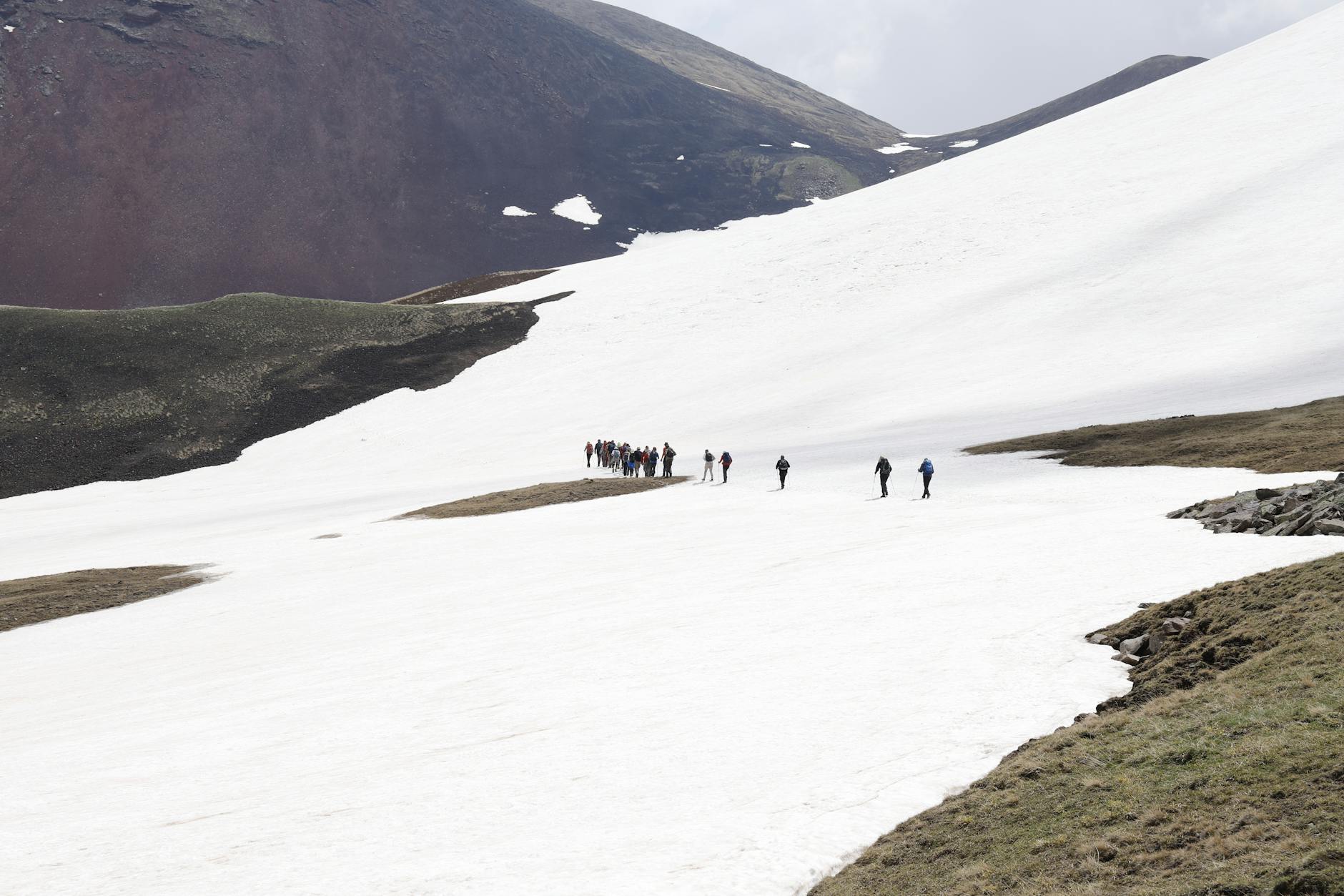 Person hiking in remote mountainous terrain with clear sky visibility