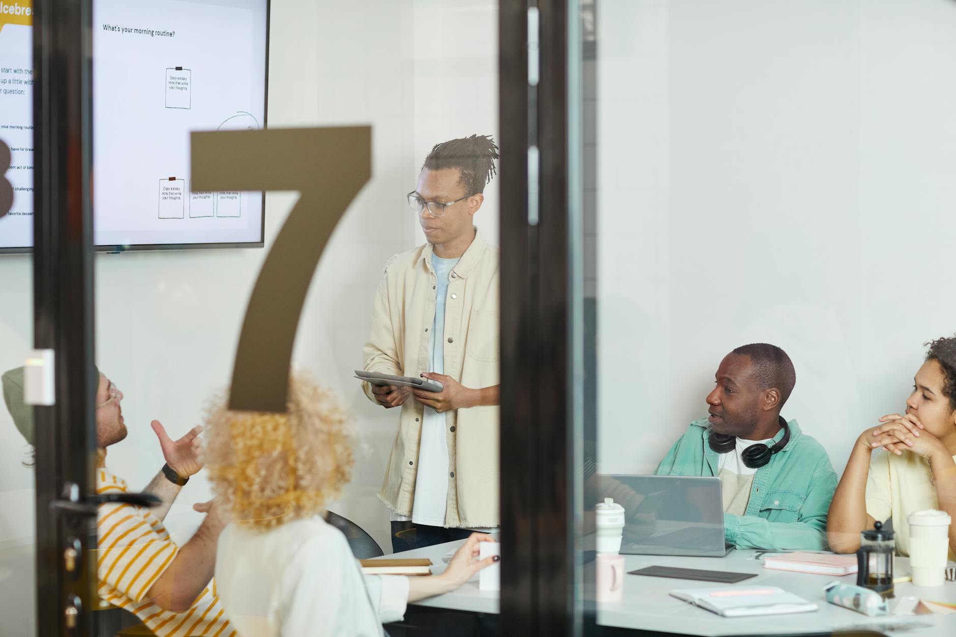 Modern conference room with people analyzing data on large display screens