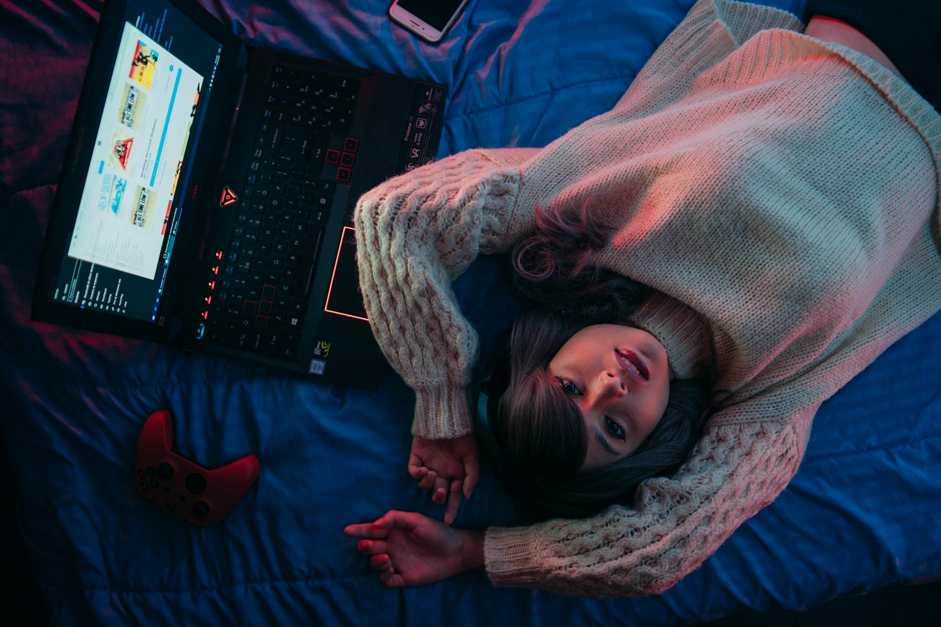 Person gaming on laptop with colorful screen display