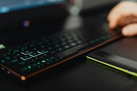 Valve’s Proton Compatibility Layer Is Quietly Killing Windows-Only Game Deals A gaming laptop on a desk representing PC gaming platform choices