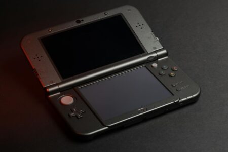 Asus ROG Ally X Is Pressuring Valve to Rethink Steam Deck Pricing A handheld gaming device resting on a surface, representing the portable PC gaming market