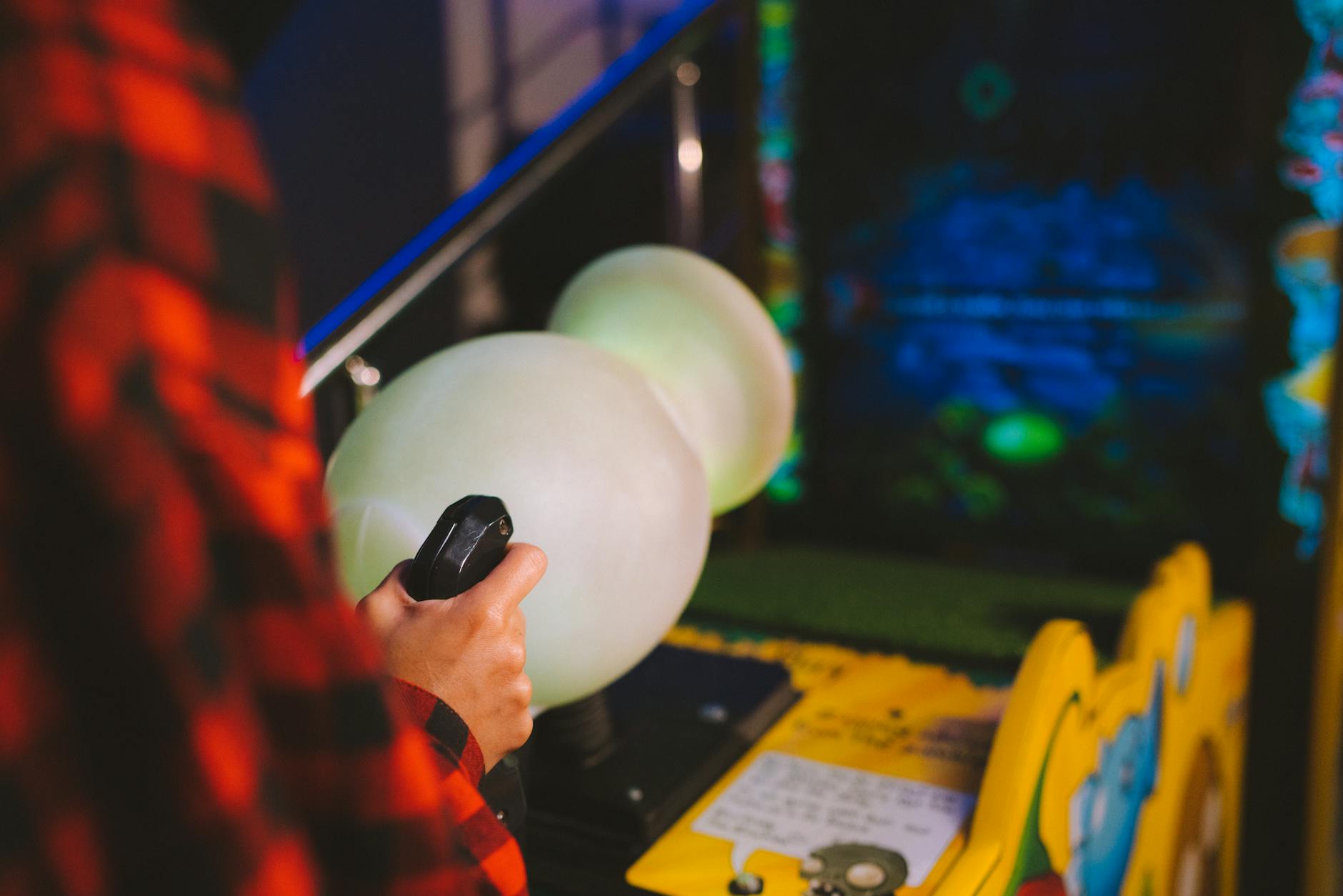 A classic arcade game cabinet in a dimly lit gaming venue