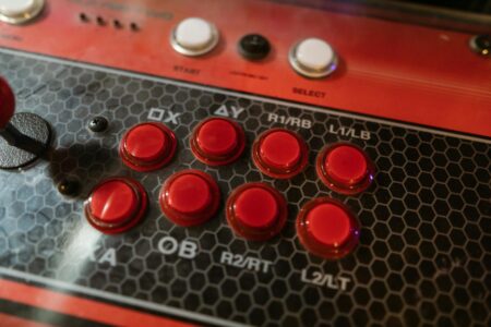 Arcade Stick Builders Are Cannibalizing Mainstream Controller Sales Close-up of a custom arcade stick with colorful buttons and a joystick lever on a desk