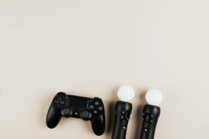 A clip-on gaming controller attached to a smartphone showing console-style analog sticks and triggers