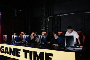 Valve’s Deadlock Beta Is Quietly Draining TF2’s Remaining Player Base Multiple gaming monitors showing team-based multiplayer games in a PC gaming setup
