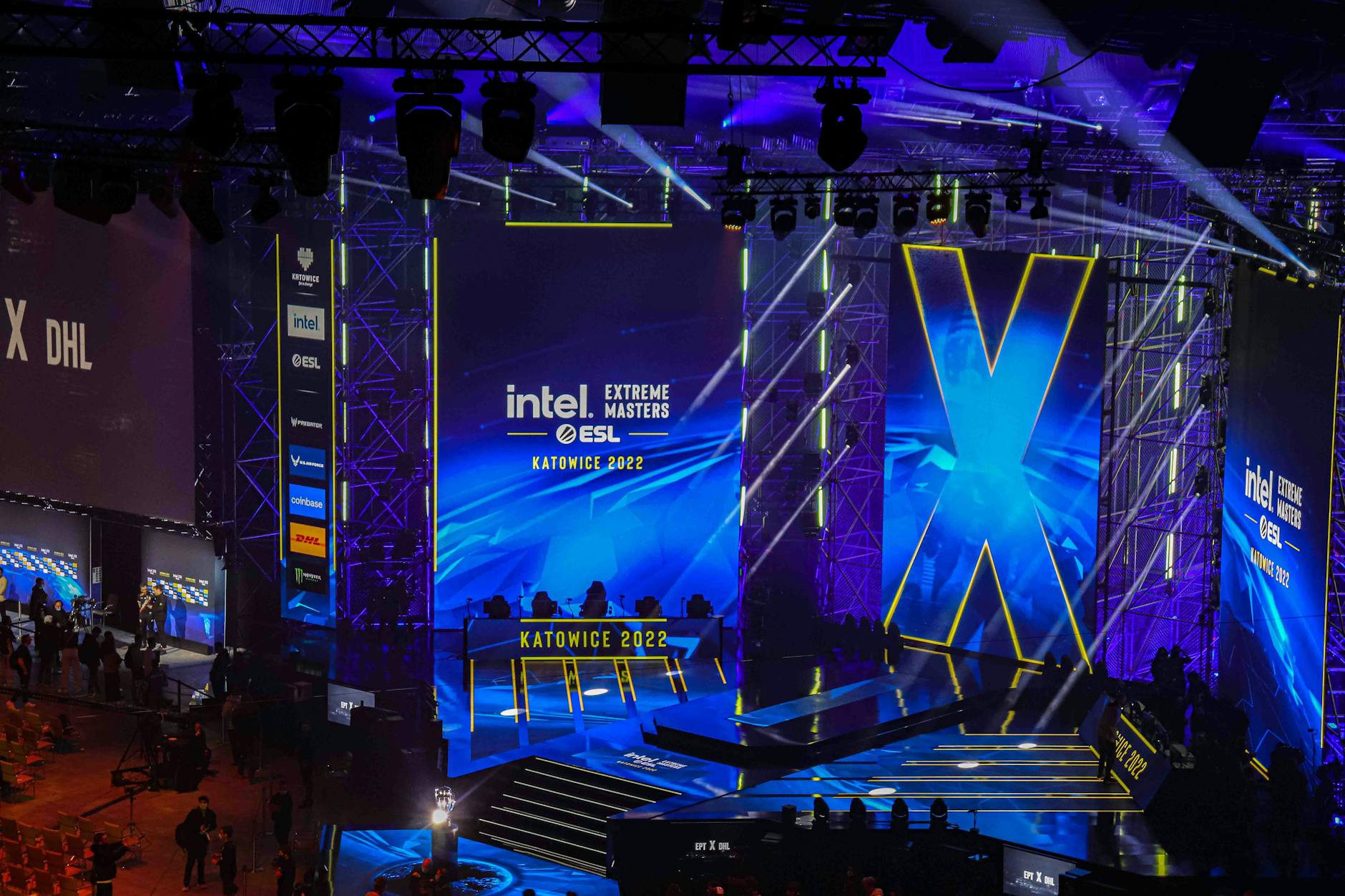 Competitive players watching a live esports tournament match on a large screen