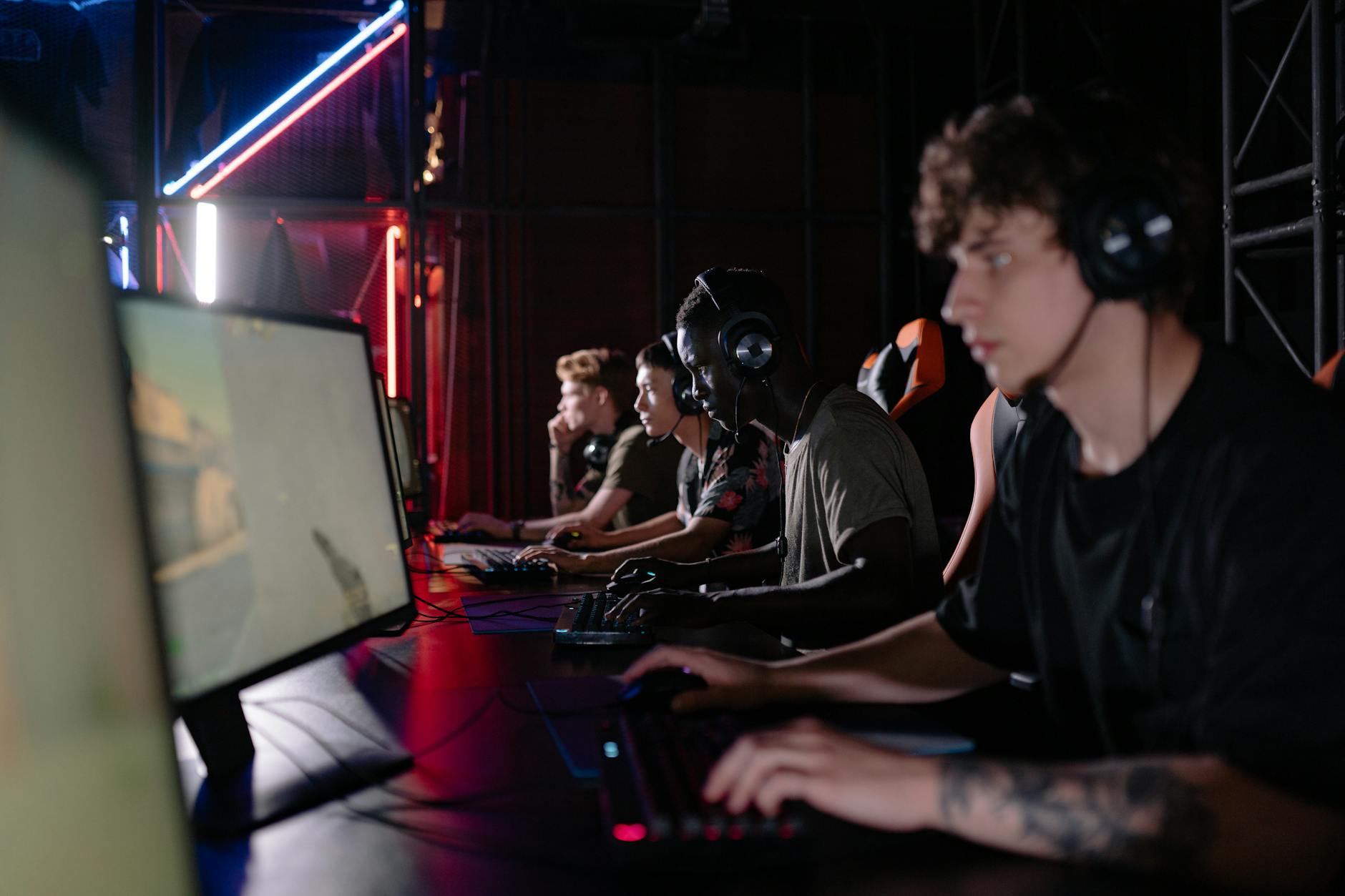 A player focused on a competitive game displayed on a PC monitor