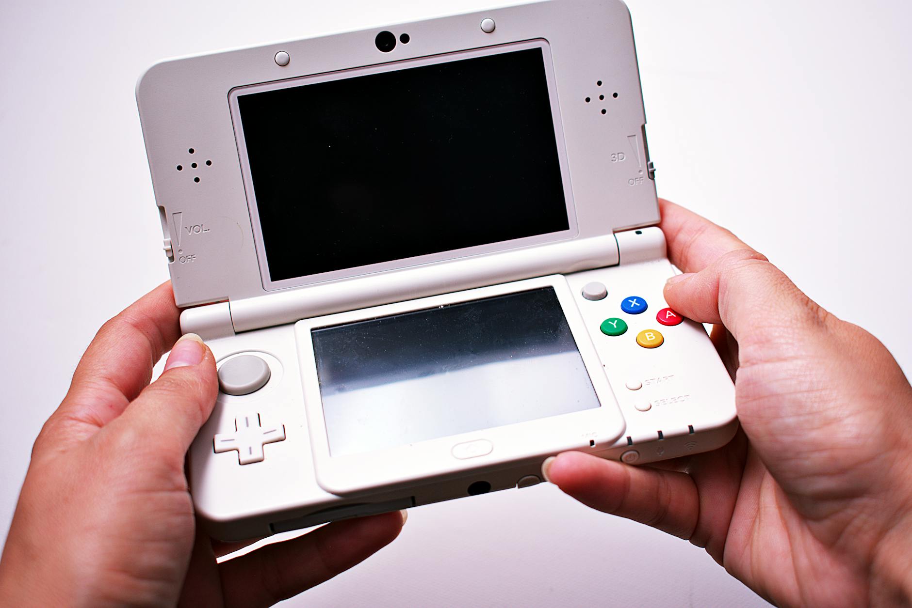 Person holding portable gaming device in hands