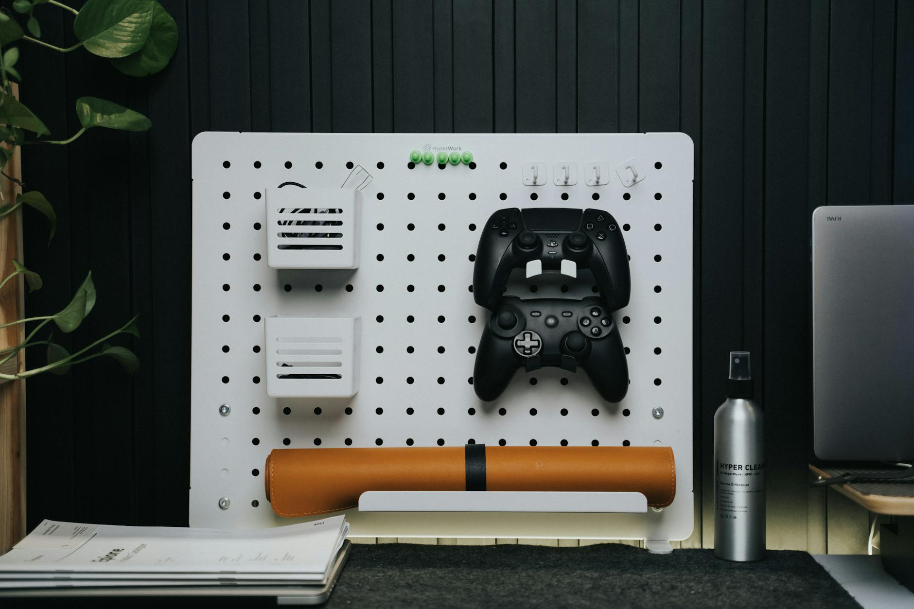 Gaming peripherals and accessories arranged on a desk including controllers and mobile devices