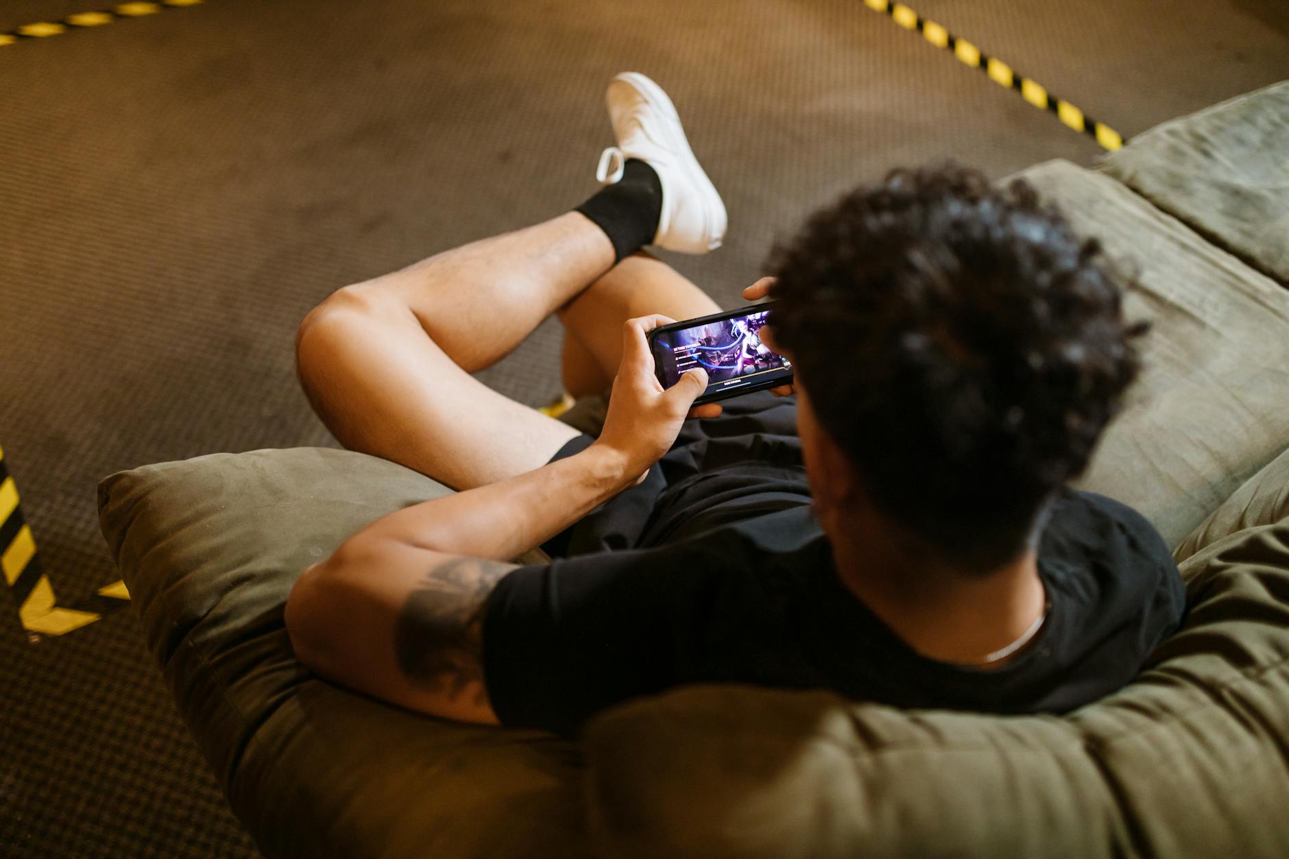 Portable gaming device being held in hands showing gaming interface