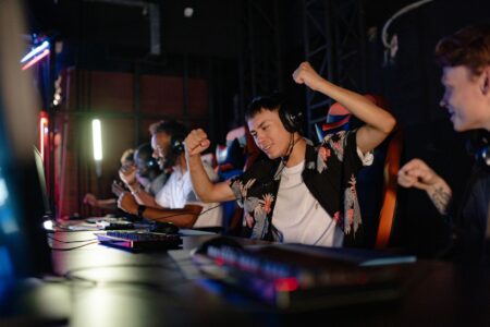 Riot’s League of Legends Veteran Players Are Defecting to Deadlock A dark gaming setup with multiple monitors glowing, representing competitive PC gaming culture