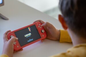 Nintendo Switch 2’s Launch Lineup Is Quietly Sidelining the 3DS Library A handheld gaming device resting on a surface, representing portable gaming history
