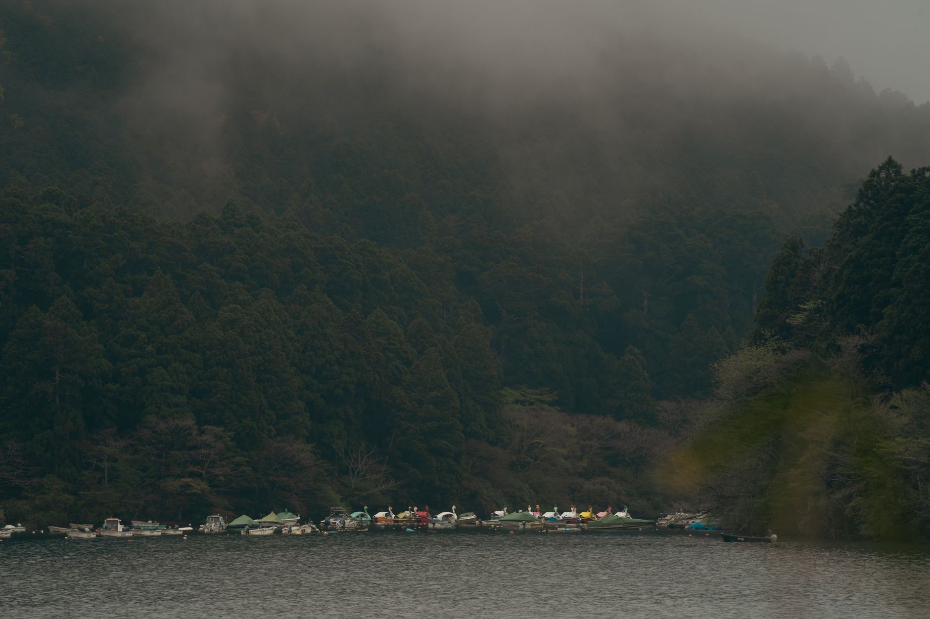 Misty Japanese landscape with mountains and forest, evoking the setting of Ghost of Tsushima