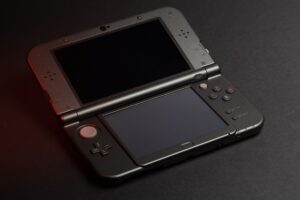 A handheld gaming PC resting on a desk, representing the current state of portable gaming hardware