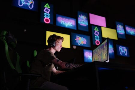 A gamer sitting in front of a screen with a look of frustration during gameplay