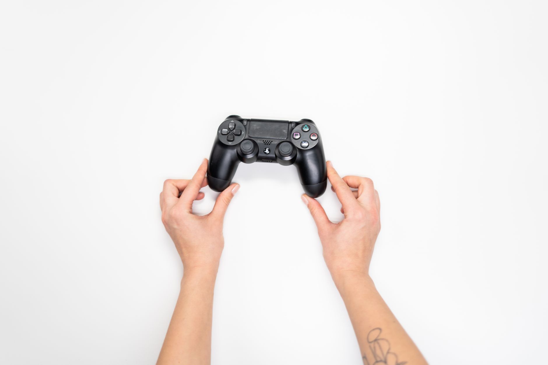 A person holding a game controller while playing on a console