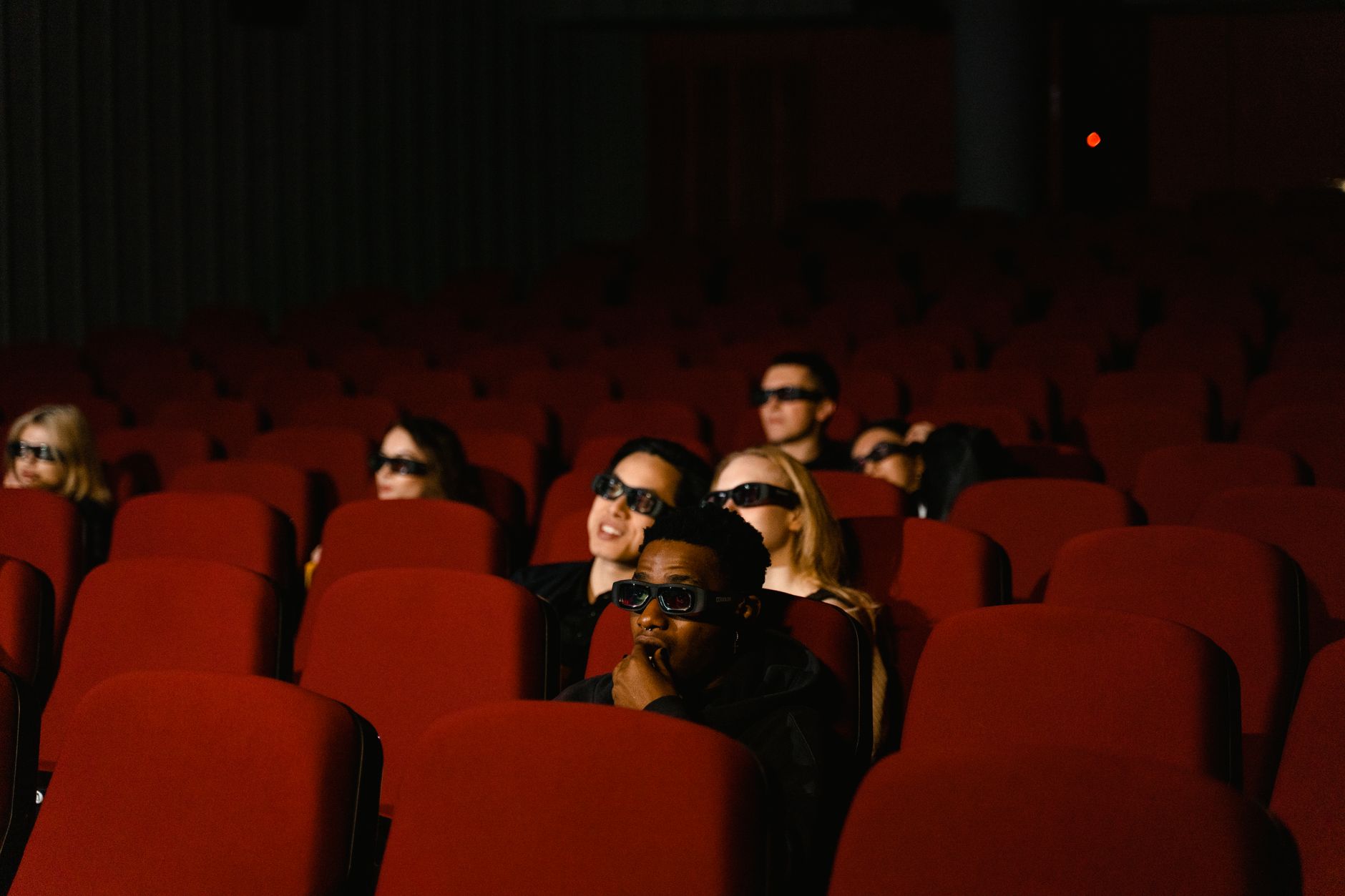 Audience watching a film in a darkened movie theater