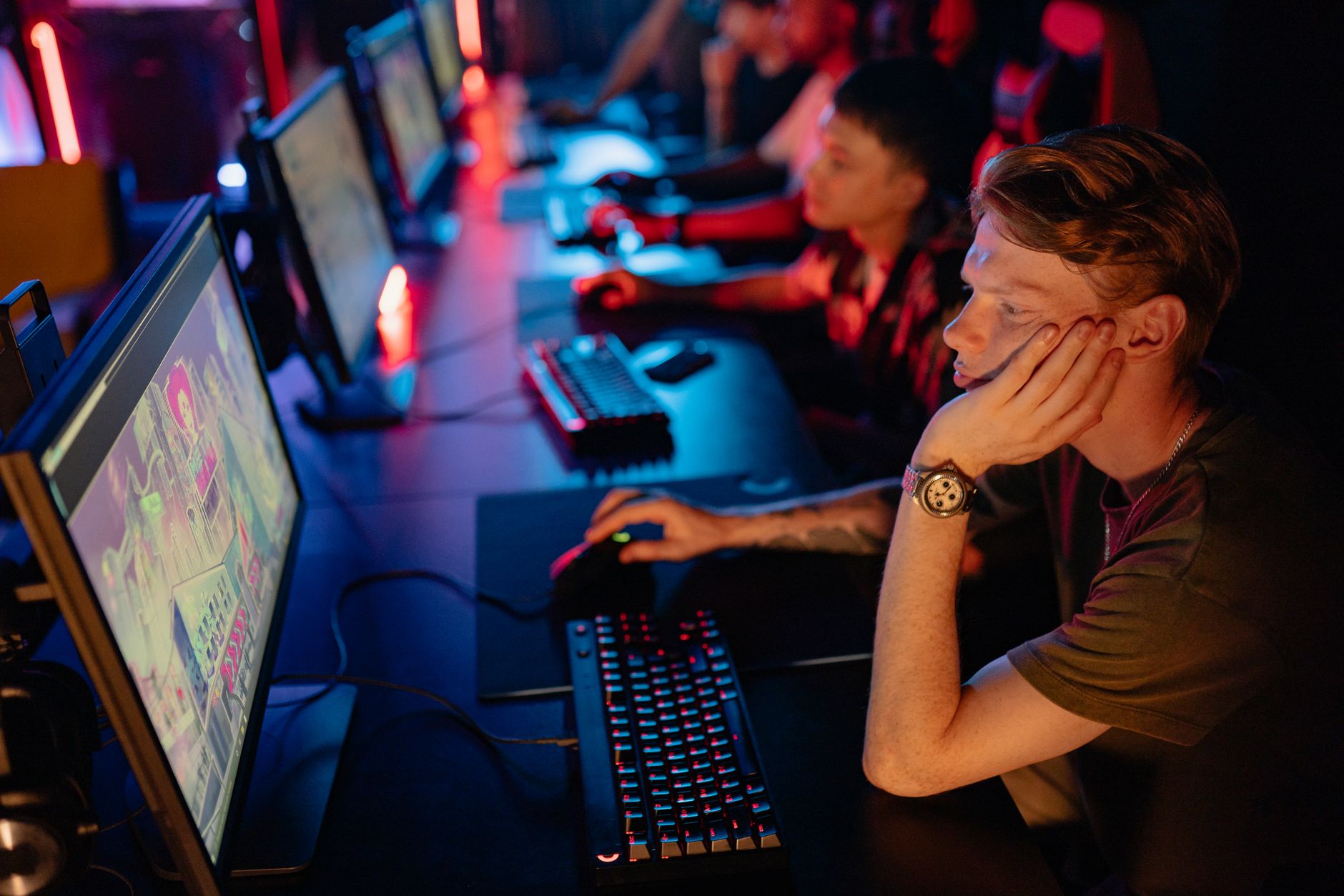 A focused esports player in front of a monitor during a competitive match