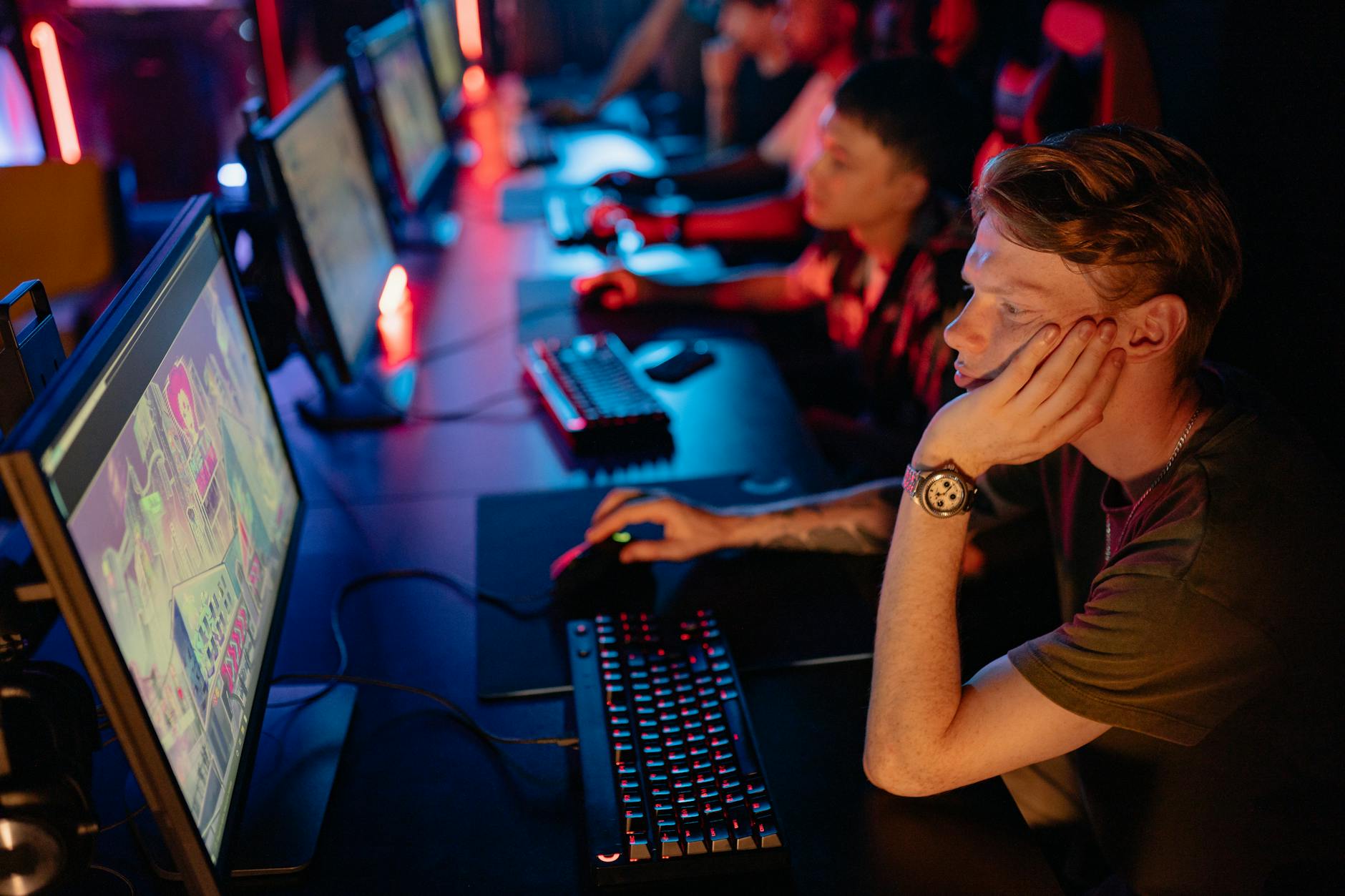 An esports arena with glowing screens, representing competitive multiplayer gaming events
