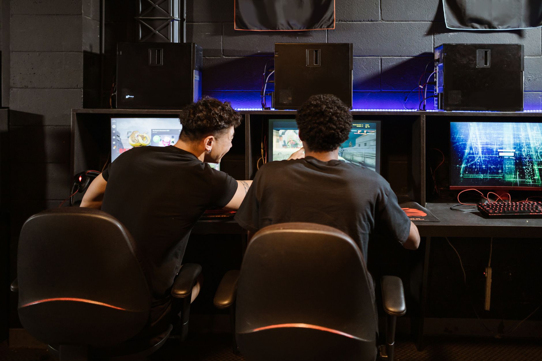A person playing a competitive PC game at their gaming desk