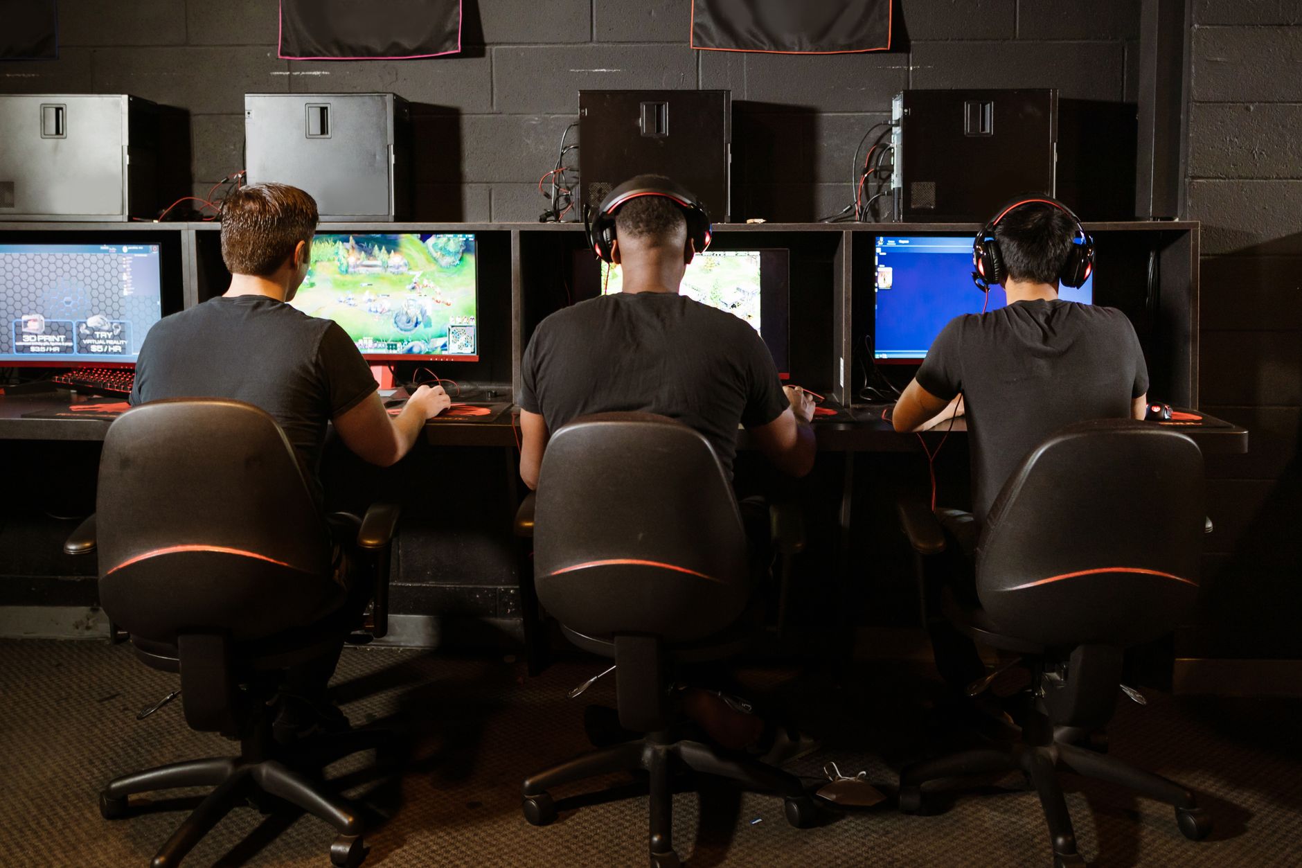 A gaming desk setup with multiple screens showing an active multiplayer session