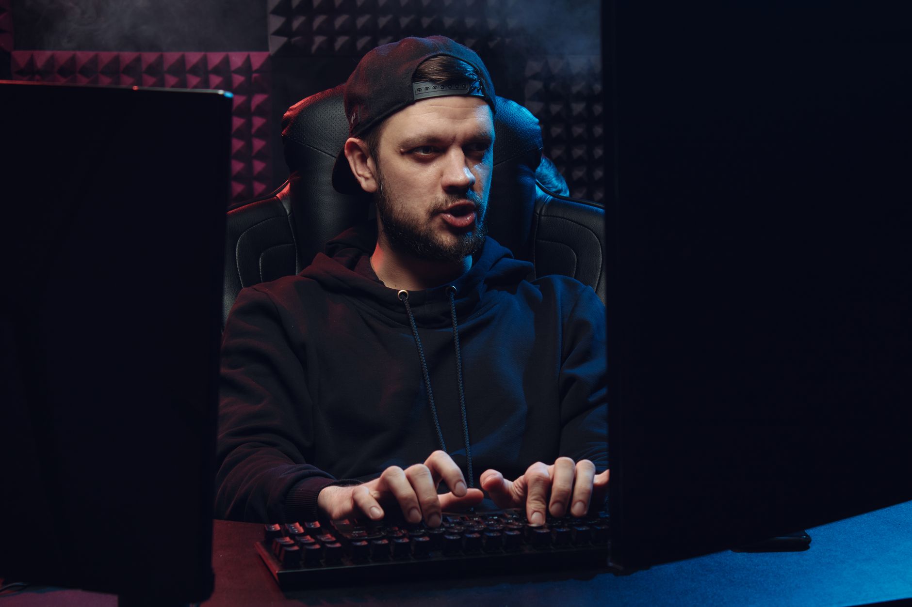 Developer at a workstation reviewing code and player feedback