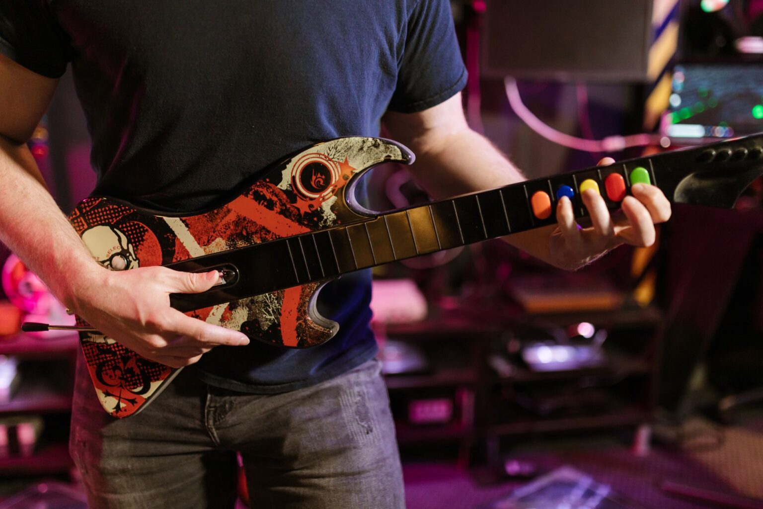 Activision’s Guitar Hero Silence Is Sending Fans Back to Clone Hero A plastic guitar controller resting on a desk, used for rhythm games like Guitar Hero and Clone Hero