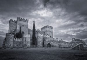 A dark, atmospheric gothic castle surrounded by fog, evoking the visual tone of Resident Evil Village