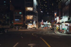 Neon-lit urban street at night evoking a retro Miami aesthetic similar to GTA Vice City