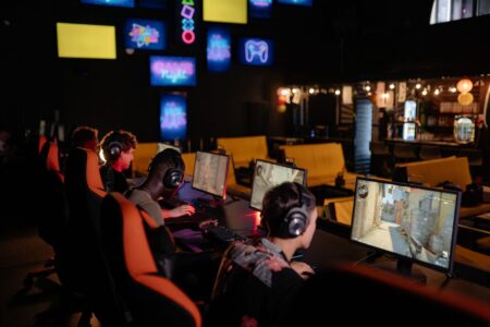Riot’s Teamfight Tactics Ranked Reset Is Quietly Bleeding Its Core Base Player focused on a competitive strategy game on a monitor at a gaming desk
