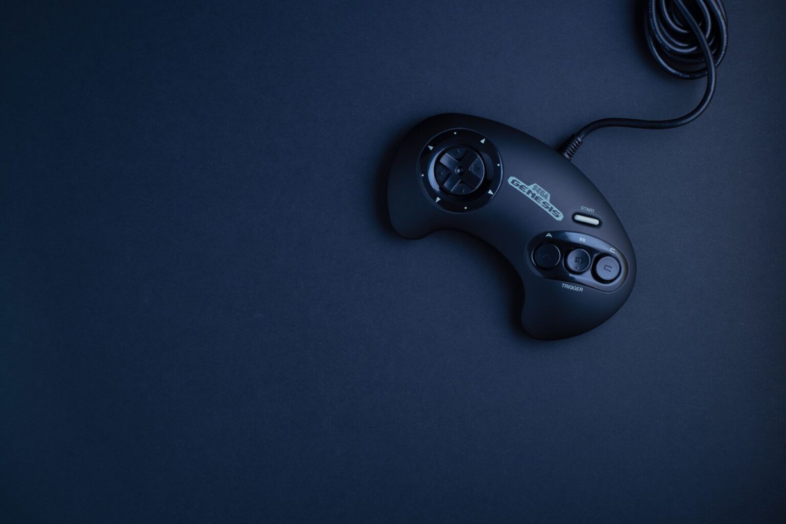 A gaming controller resting on a dark surface, representing competitive multiplayer gaming