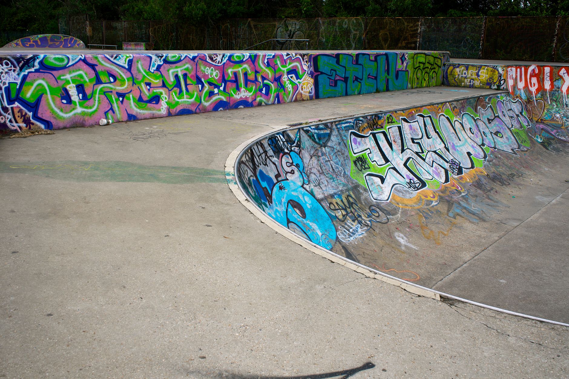 Empty concrete skatepark under natural light, representing indie skating culture