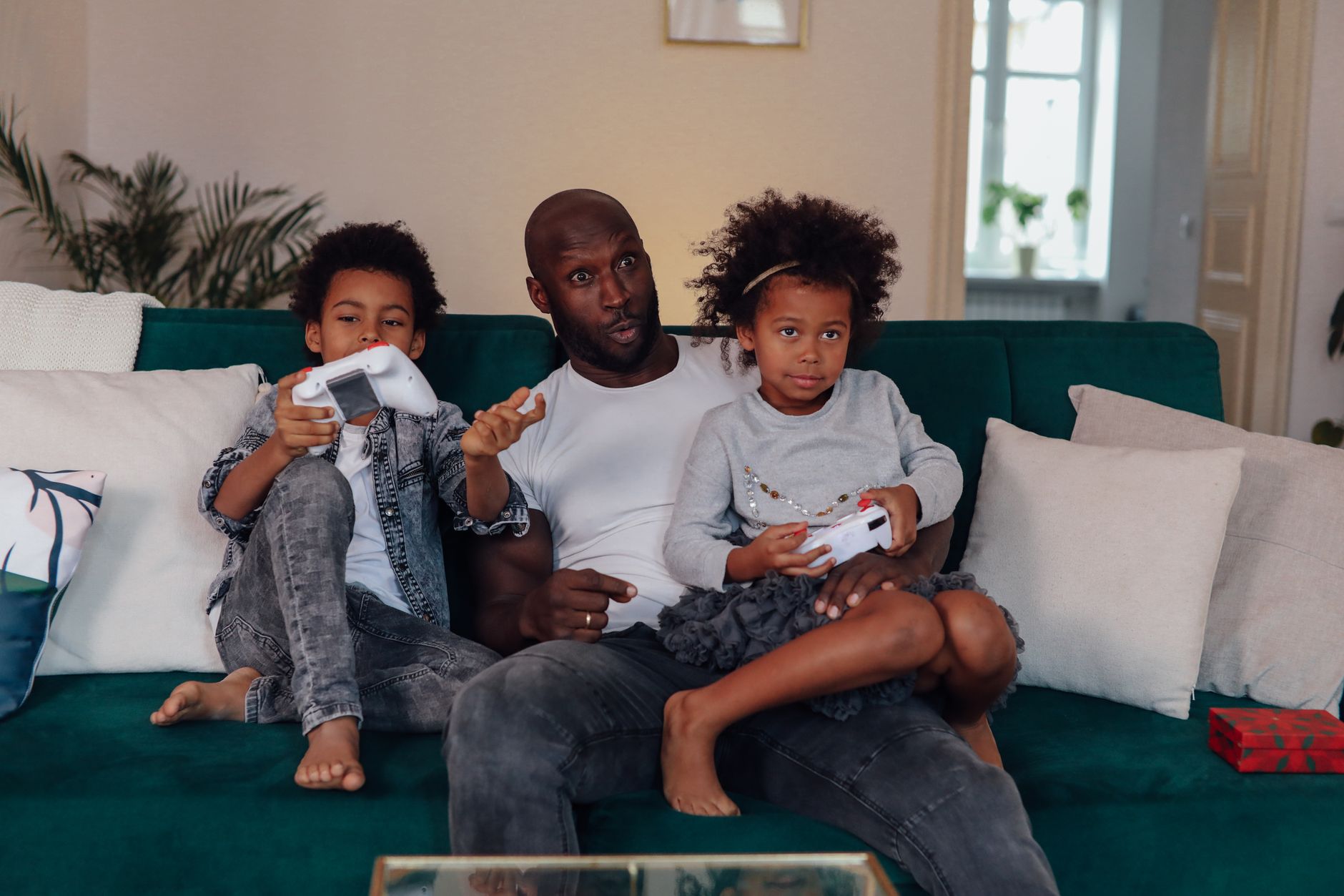 Family sitting together playing video games at home, representing Nintendo's core audience