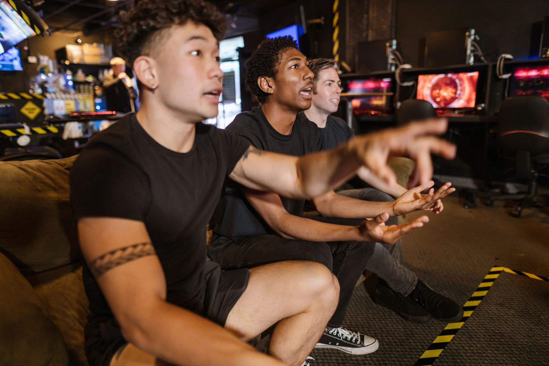 A crowd gathered around gaming screens at a competitive gaming event