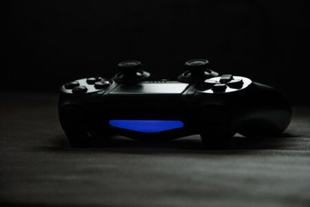 A gaming controller resting on a dark surface, representing console gaming anticipation